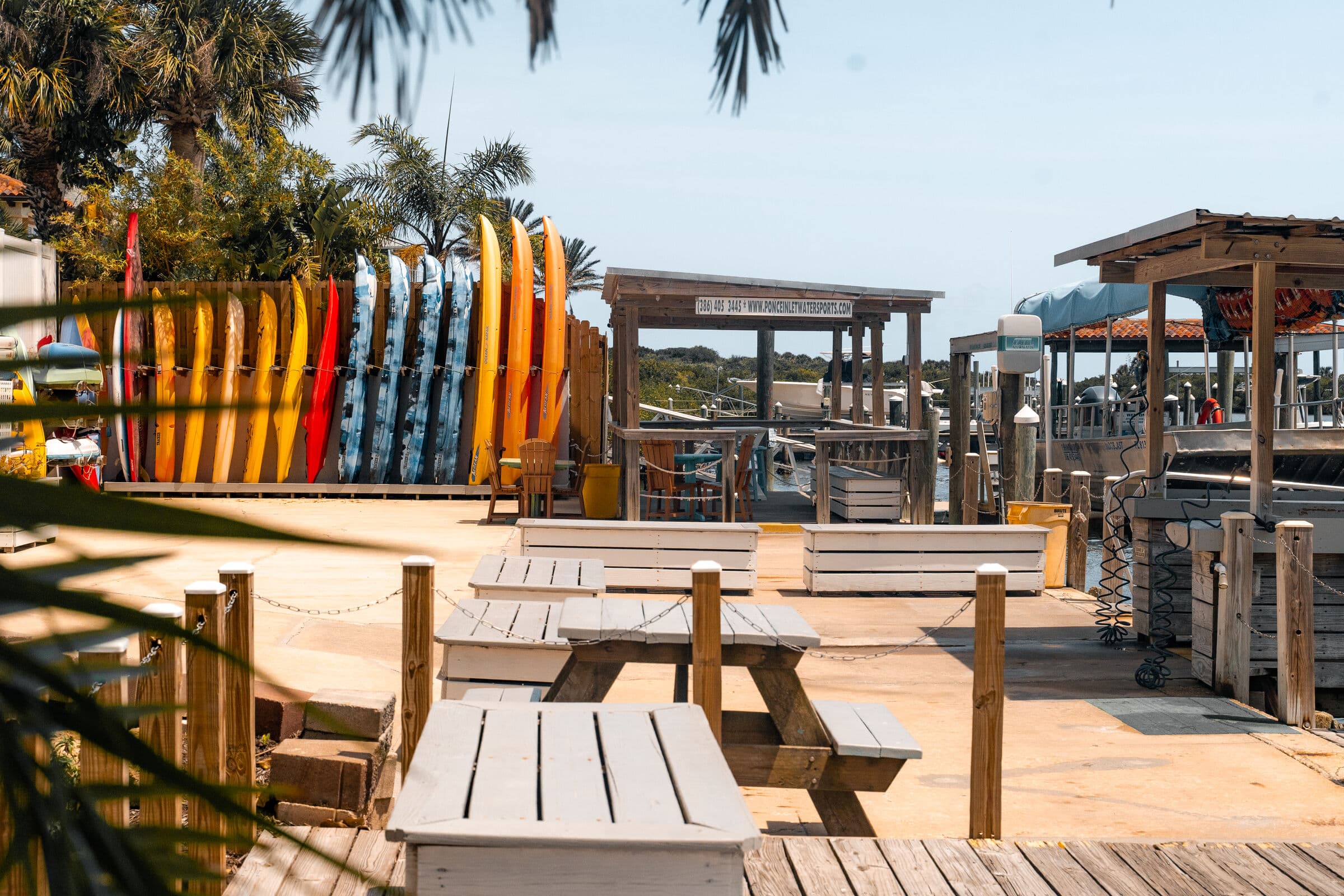 Dockside courtyard with tables, the kayak racks and the covered decks.